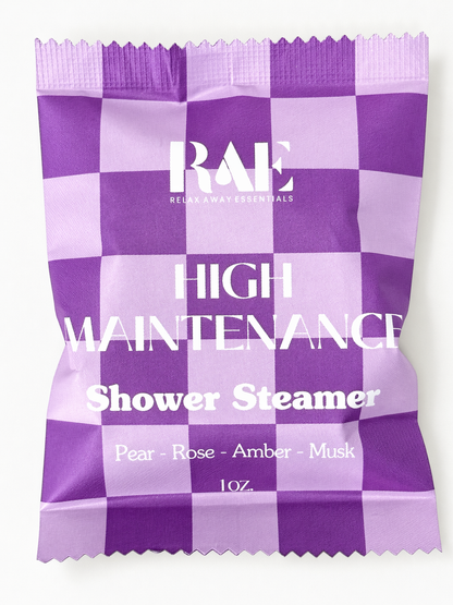 Purple and white checkered shower steamer packaging with 'RAE' branding.