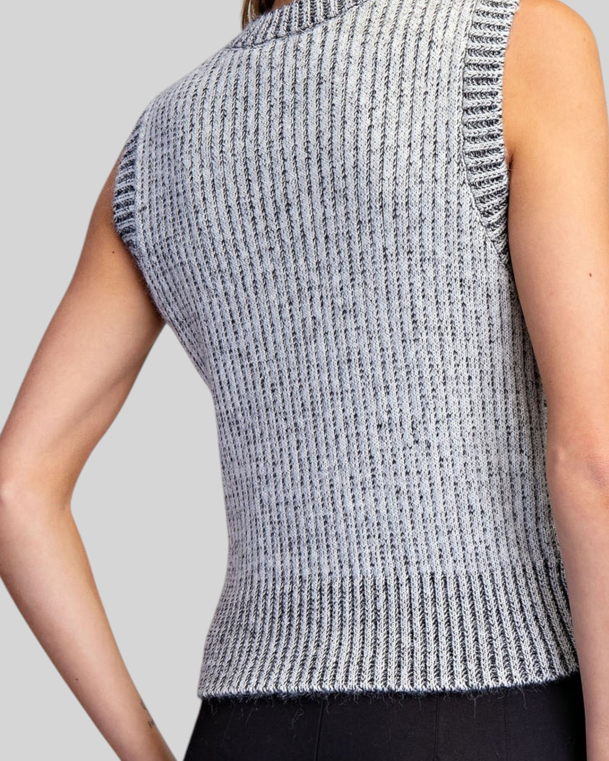 Back view of a ribbed sleeveless charcoal and ivory sweater vest.