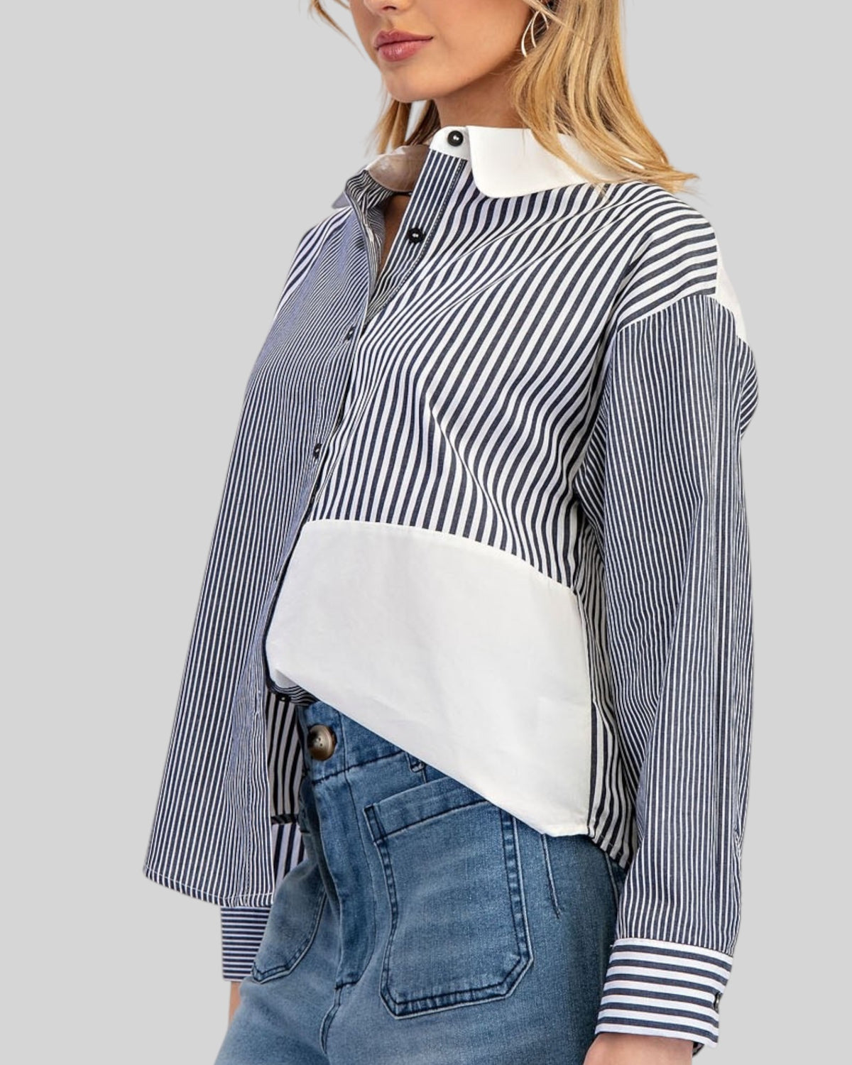 Women wearing a charcoal and white button down shirt with mixed stripe pattern.