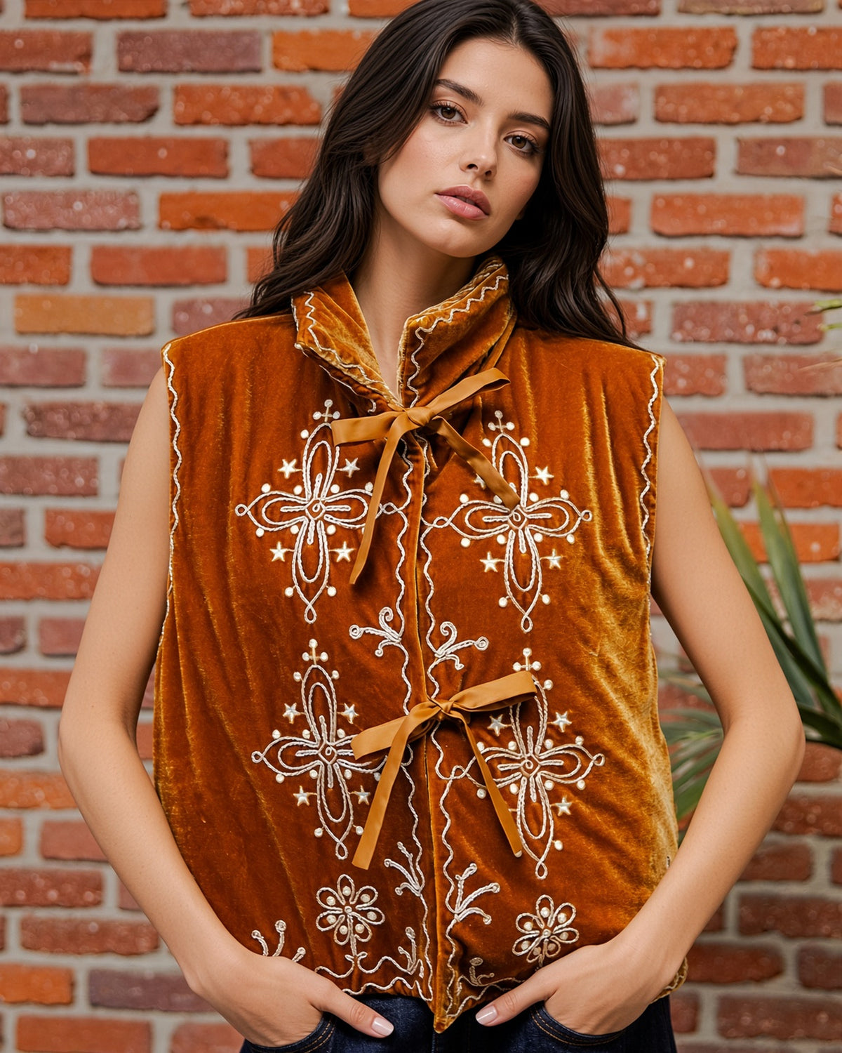 Woman wearing a vintage inspired Copper velour vest with ivory floral embroidery, oversized collar, tie-front closures, and scalloped trim.