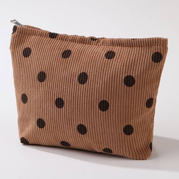 Brown corduroy make-up bag with dark brown polka dots on a white background.