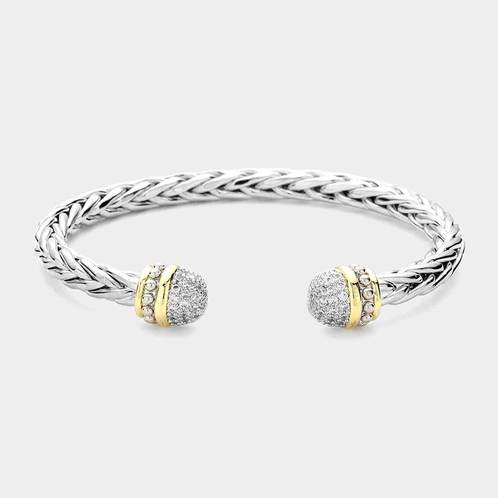 Silver bracelet with gold and diamond accents on a light gray background.