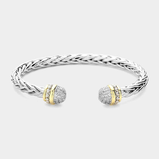 Silver bracelet with gold and diamond accents on a light gray background.