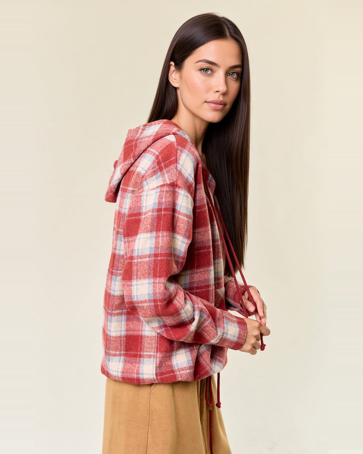 Side view of cranberry plaid flannel hoodie showing the attached hood, long sleeves and relaxed fit.