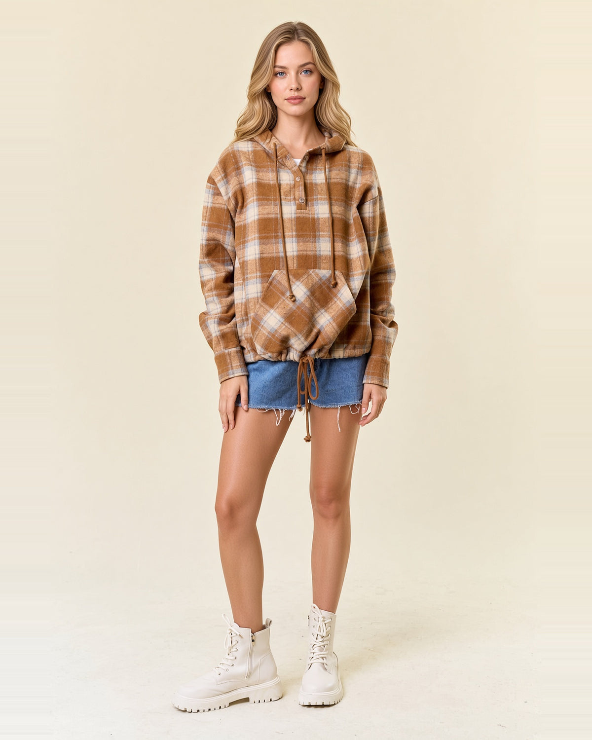 Full-length model wearing acorn brown plaid flannel hoodie with denim shorts.