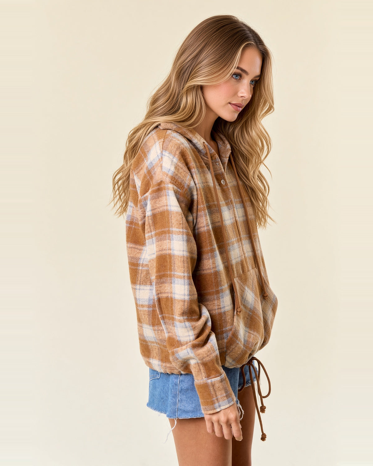 Angled side view of acorn brown plaid flannel hoodie showing long sleeves, relaxed fit and gathered hem.