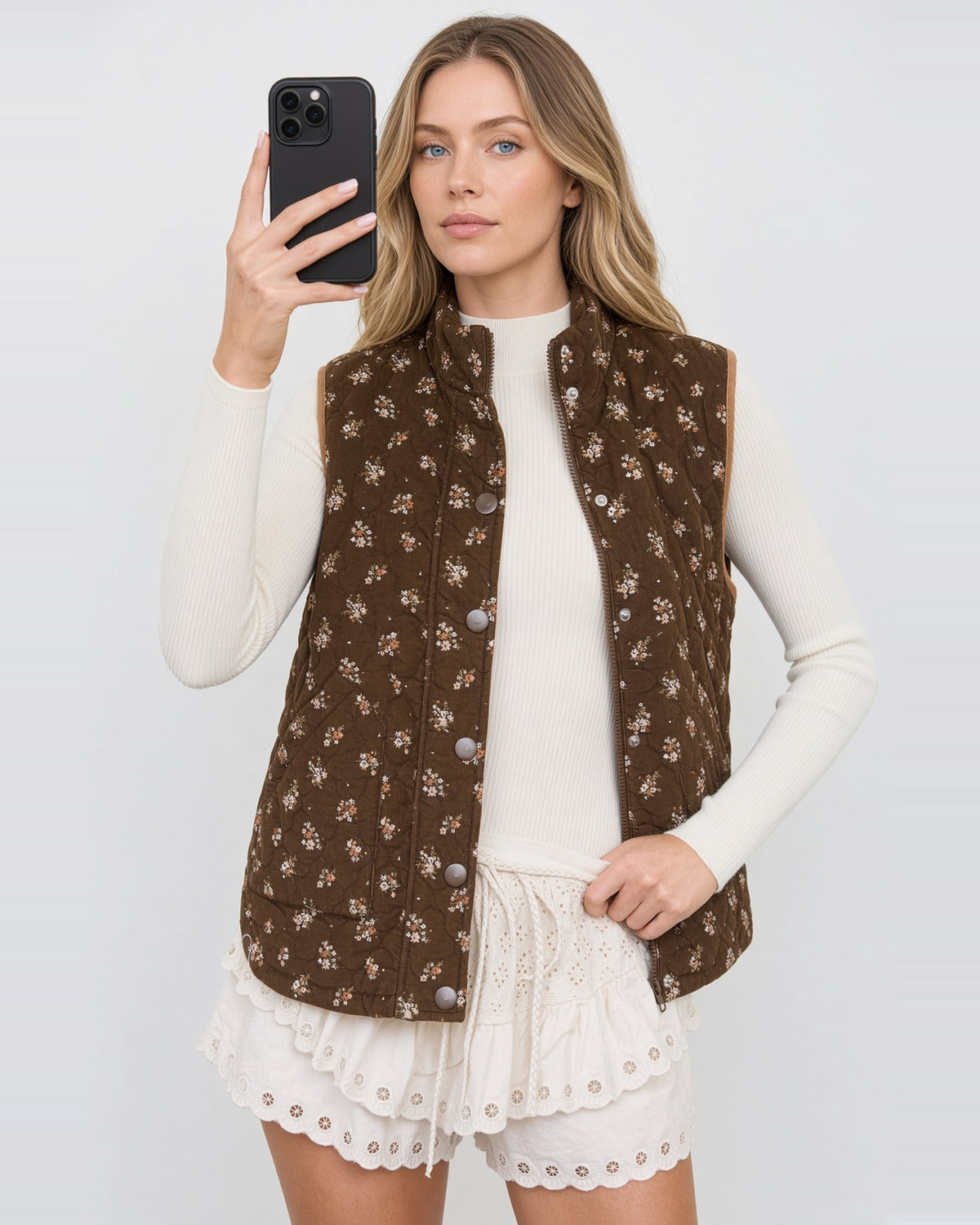 Hazel Bloom brown floral quilted vest worn open, showing the zip closure and snap-front placket.