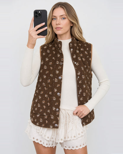 Hazel Bloom brown floral quilted vest worn open, showing the zip closure and snap-front placket.