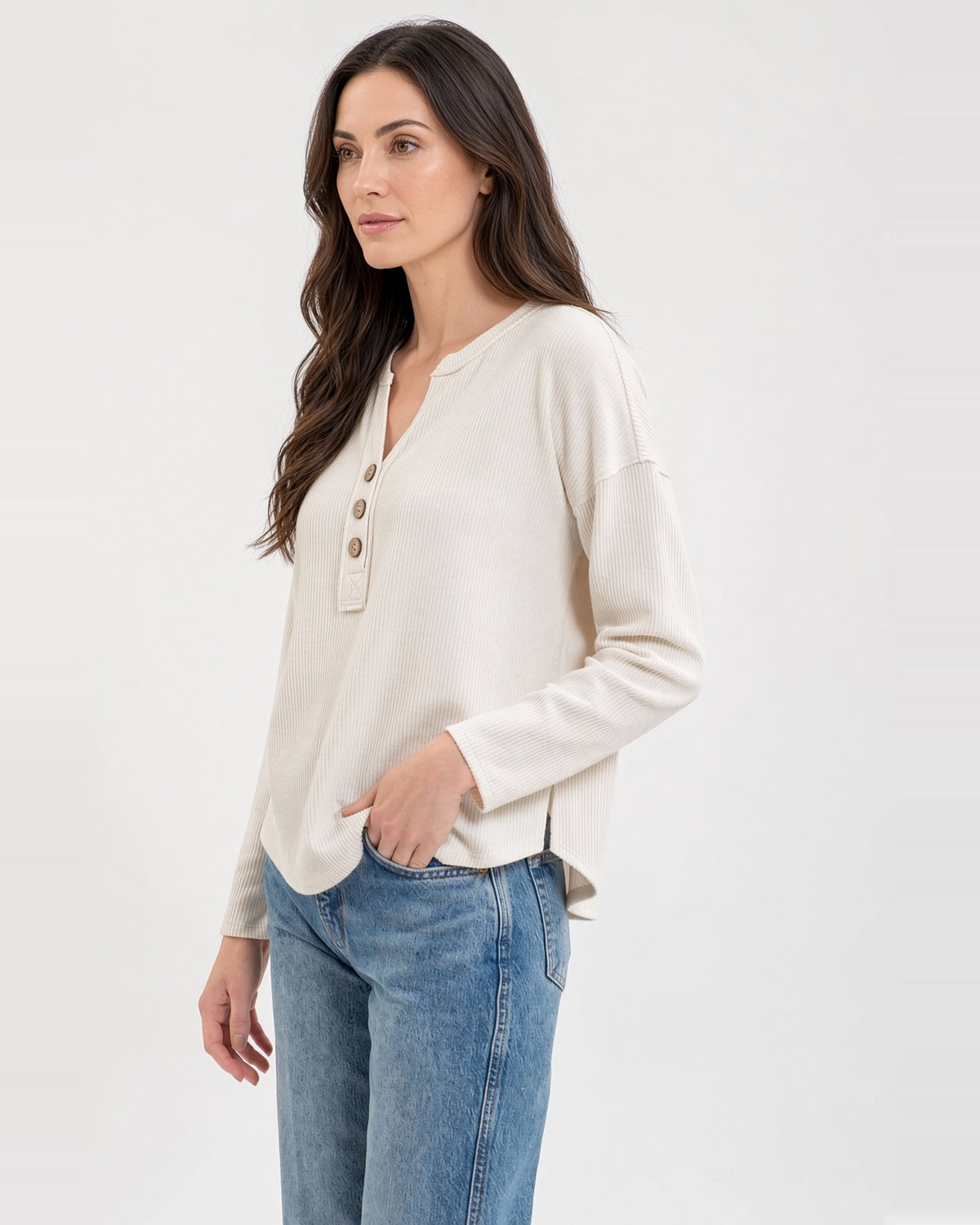 Side view of the Soft Ivory half-button top, showing dropped shoulders and a split hem with a longer back.
