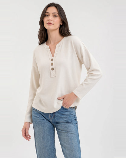 Model wearing an ivory textured knit top with a three-button neckline, long sleeves, and relaxed fit.