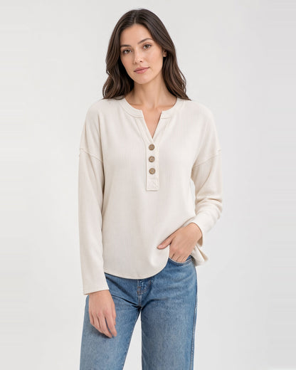 Front view of the Soft Ivory knit top, showing its open neckline, three buttons, and vertical texture.