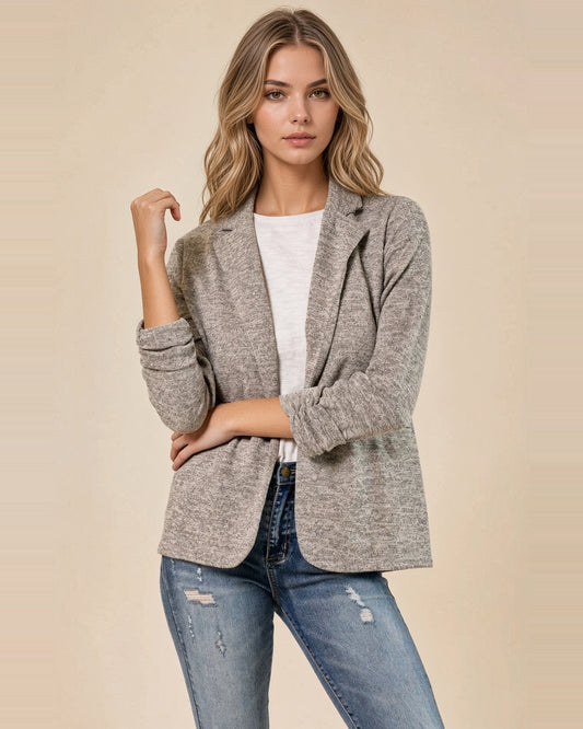 Front view of model wearing Urban Soft Knit Toffee Blazer with arms crossed, showing gathered sleeves and notched lapels.