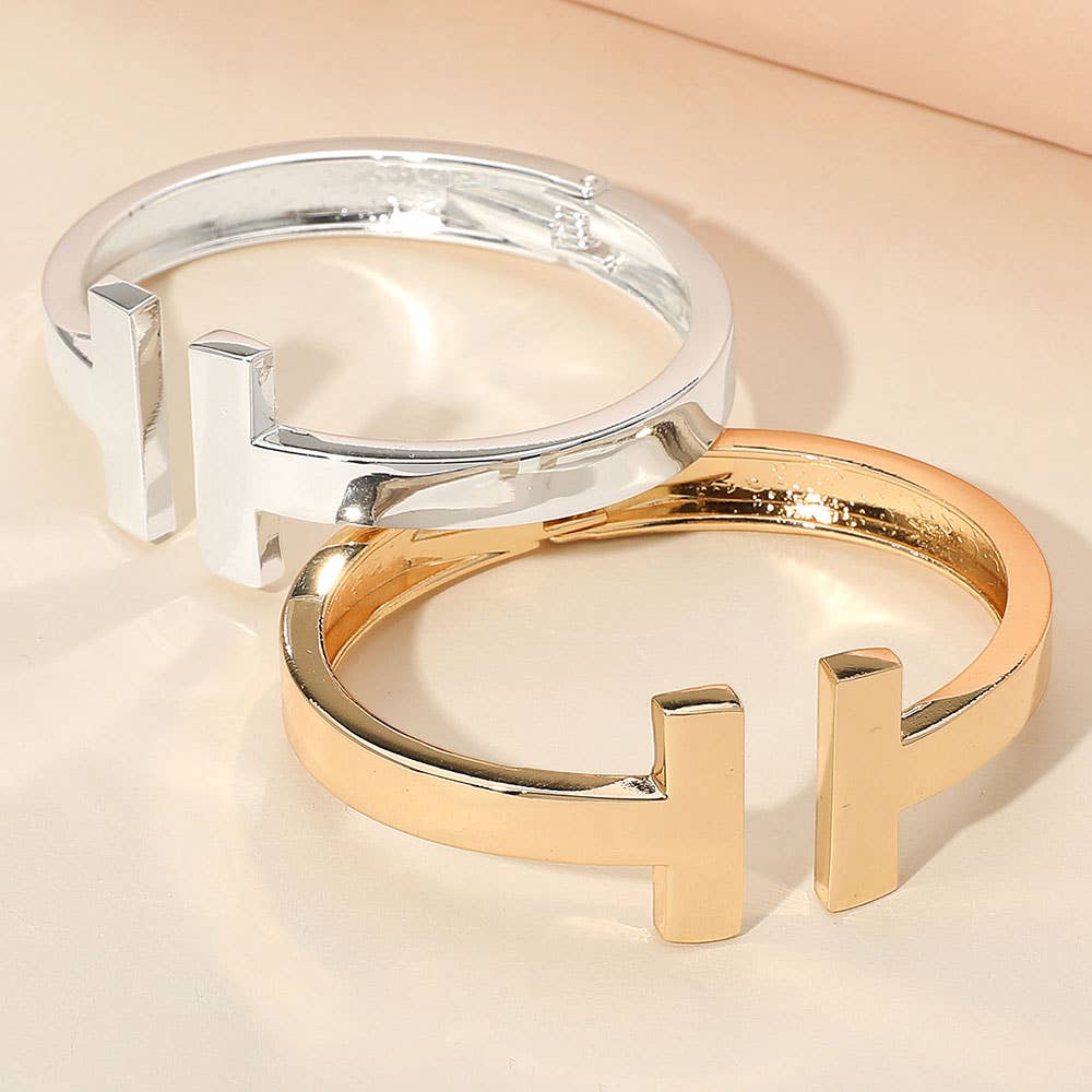 Gold and silver metal T-Tip bangle cuff bracelets.