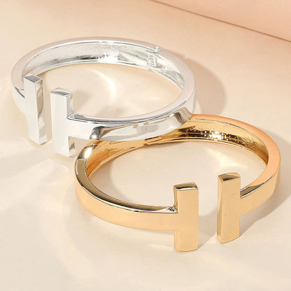 Gold and silver metal T-Tip bangle cuff bracelets.