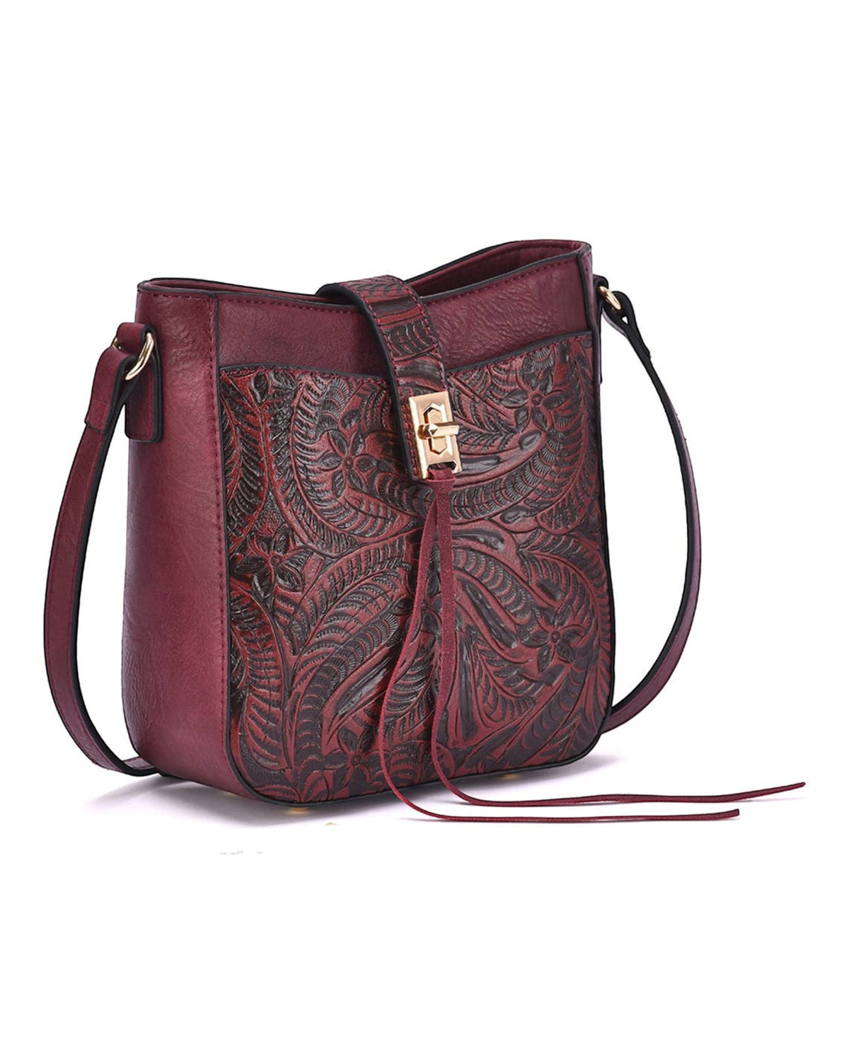A dark red leather/burgundy crossbody bag with intricate hand-tooled floral patterns on the front flap, a matching adjustable shoulder strap, and a small gold-tone turn-lock clasp, shown against a plain white background.