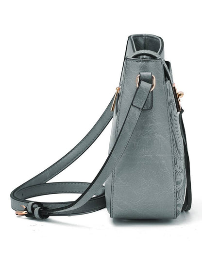 Side view of a blue-gray faux-leather semi-structured faux leather bag.