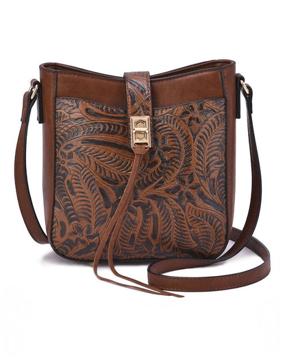 A brown/Cognac leather semi-structured faux leather bag with intricate hand-tooled floral patterns, a gold-tone turn-lock closure, and a matching adjustable shoulder strap, shown on a plain white background.