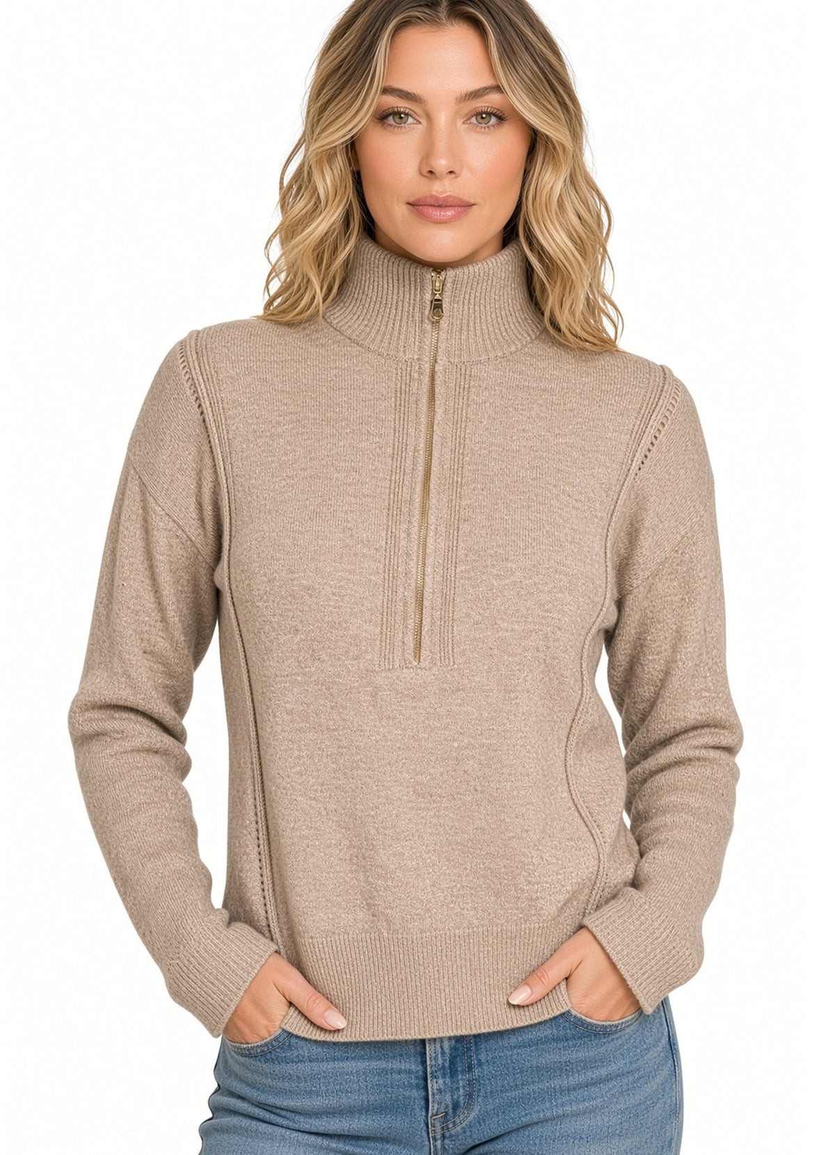 A woman modeling a heather beige/mocha ribbed knit mock neck quarter zip sweater with side pockets, paired with blue jeans against a plain white background.