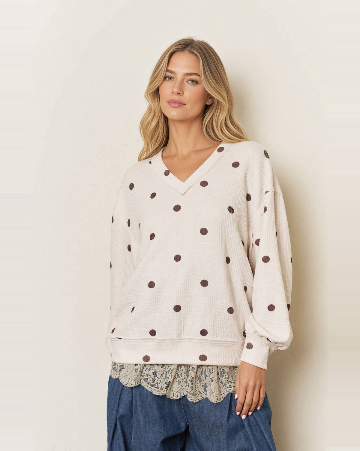 Front view of the Sweet Spot cream textured knit top with brown polka dots, a V-neckline, and banded cuffs.