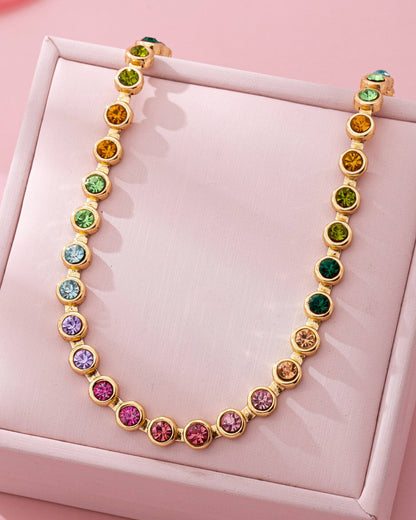 Multicolored beaded necklace on a pink jewelry box.