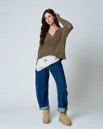 Model wearing Cocoa Bean split-neck sheer knit sweater with jeans.