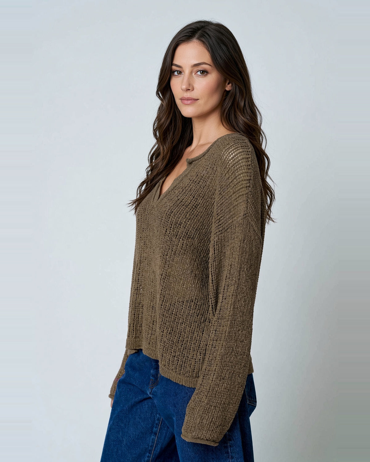 Angled view of Cocoa Bean sheer knit sweater showing dropped shoulders and relaxed fit.