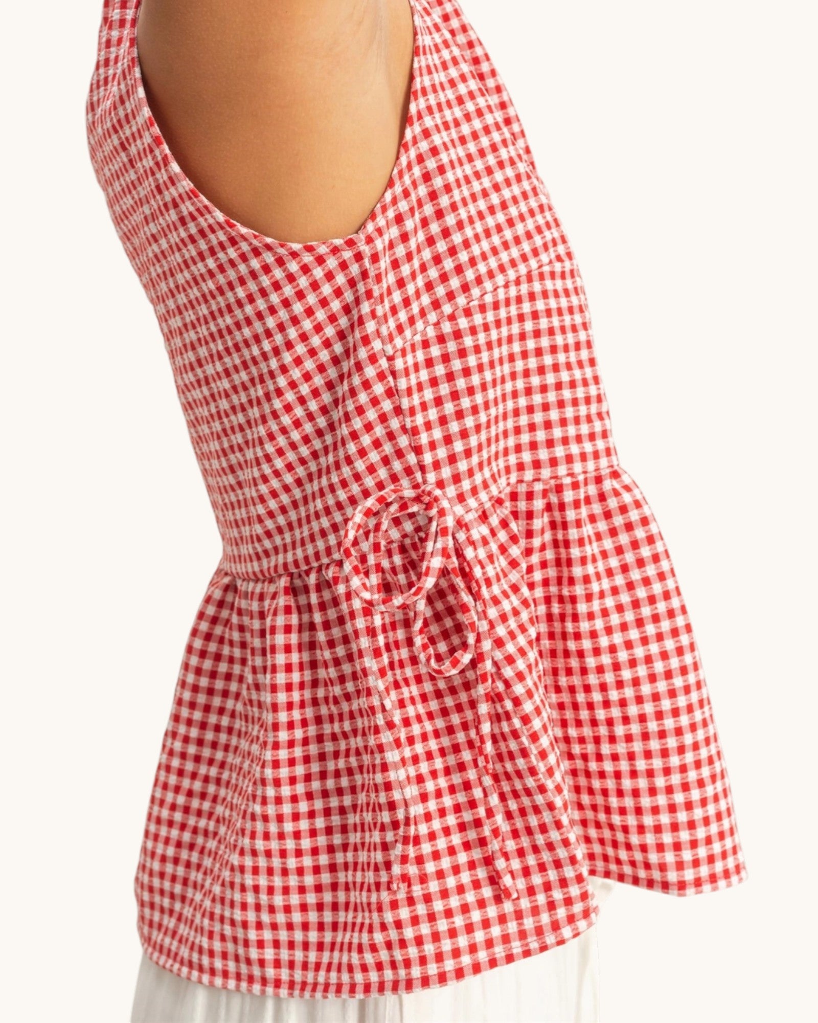 Red and white checkered top on a white background