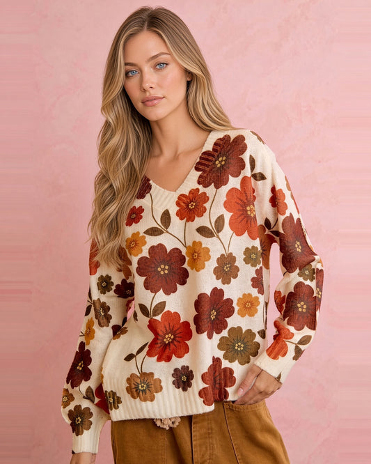Cream V-neck knit sweater with retro floral print in rust, burgundy, mustard, and olive, shown from the front.