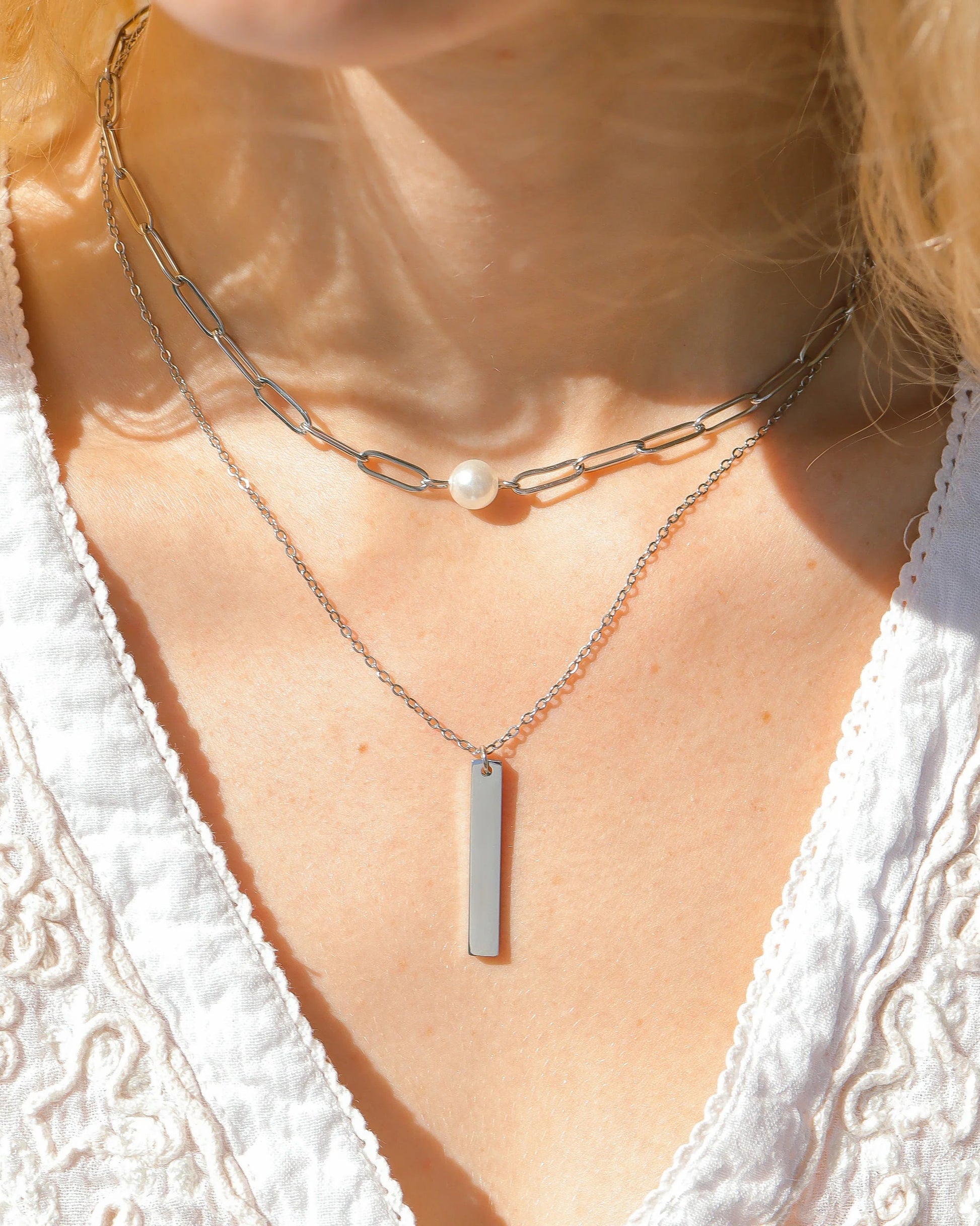 Silver waterproof paperclip pearl necklace with Kiska pearl accent. 