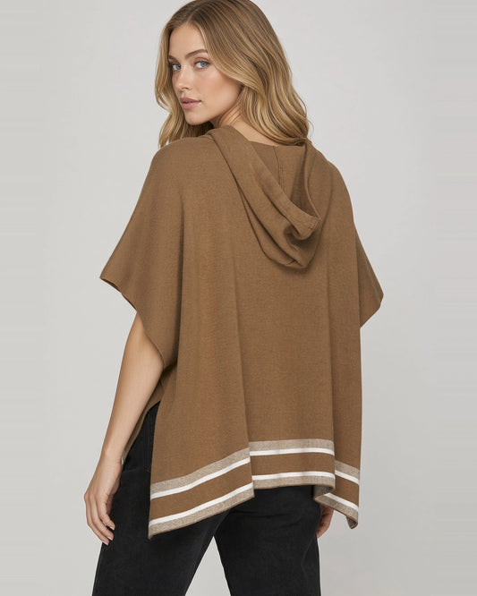 Back view of model wearing mocha brown short sleeve knit hoodie cape with contrast striped hem.