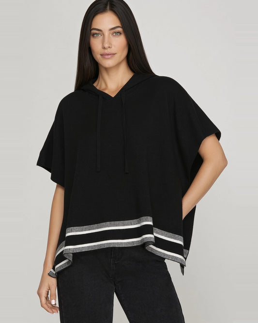 Front view of black short sleeve knit hoodie cape showing drawstring hood, relaxed fit, and gray and white striped hem.