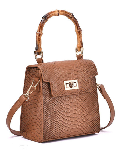 A structured brown handbag with a textured python-patterned leather exterior, a bamboo-style top handle, and a gold-tone turn-lock clasp on the front flap, shown on a white background.