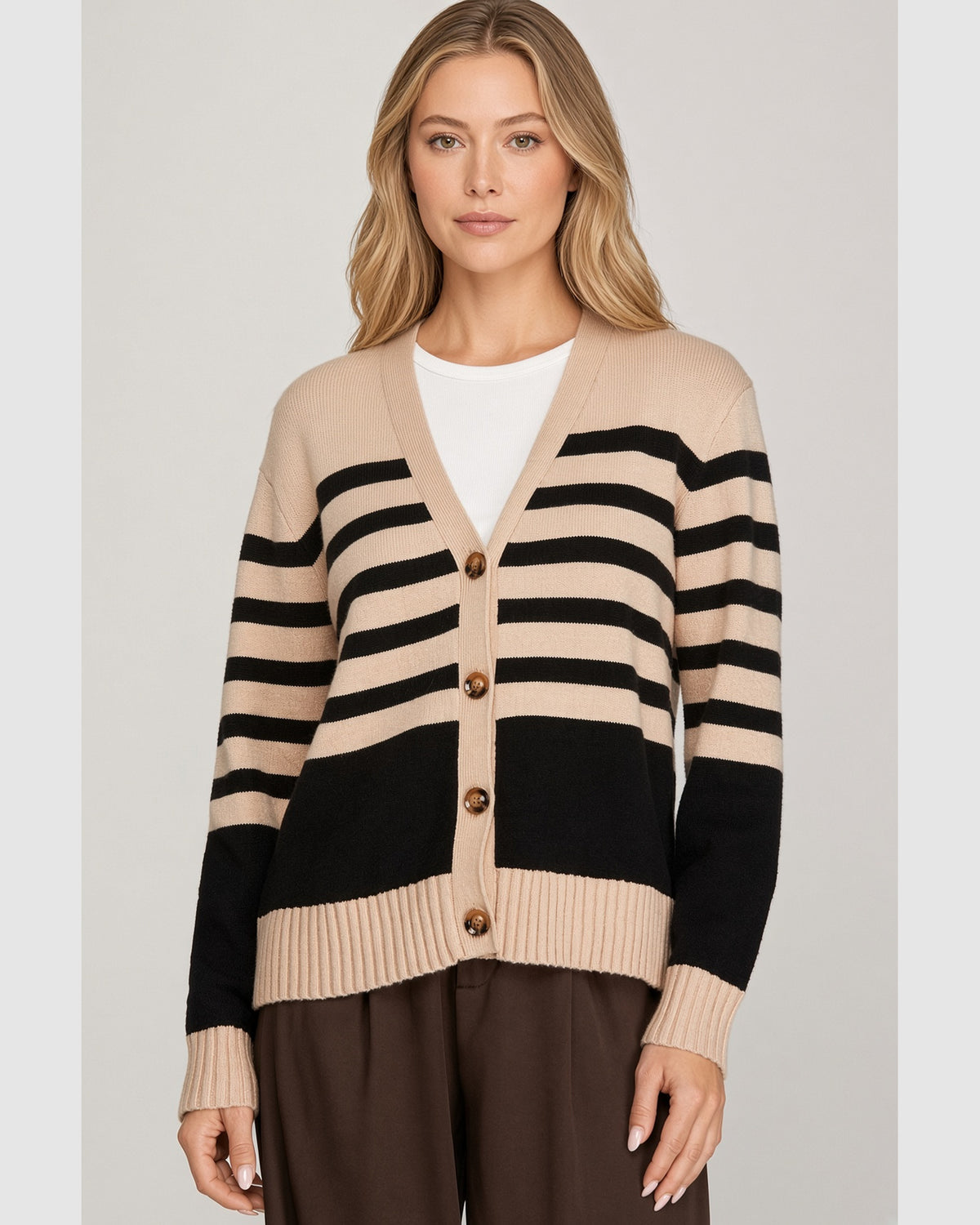 Front view of beige and black striped V-neck cardigan with brown buttons and beige ribbed cuffs and hem.