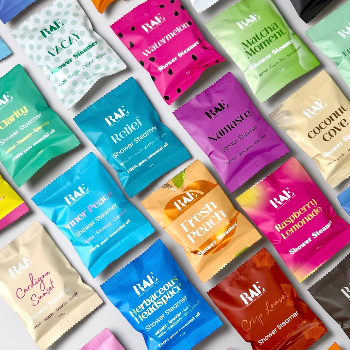 Assorted RAE Shower Steamers in various scents on a white background.