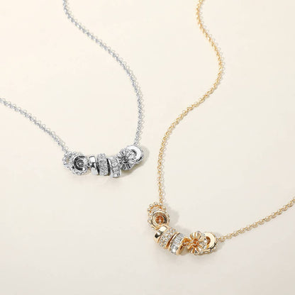 Two necklaces, one silver and one gold, with decorative elements on a light background.