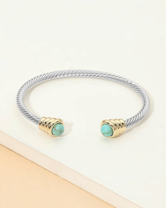 Turquoise tip silver open cuff cable bracelet with gold accents.