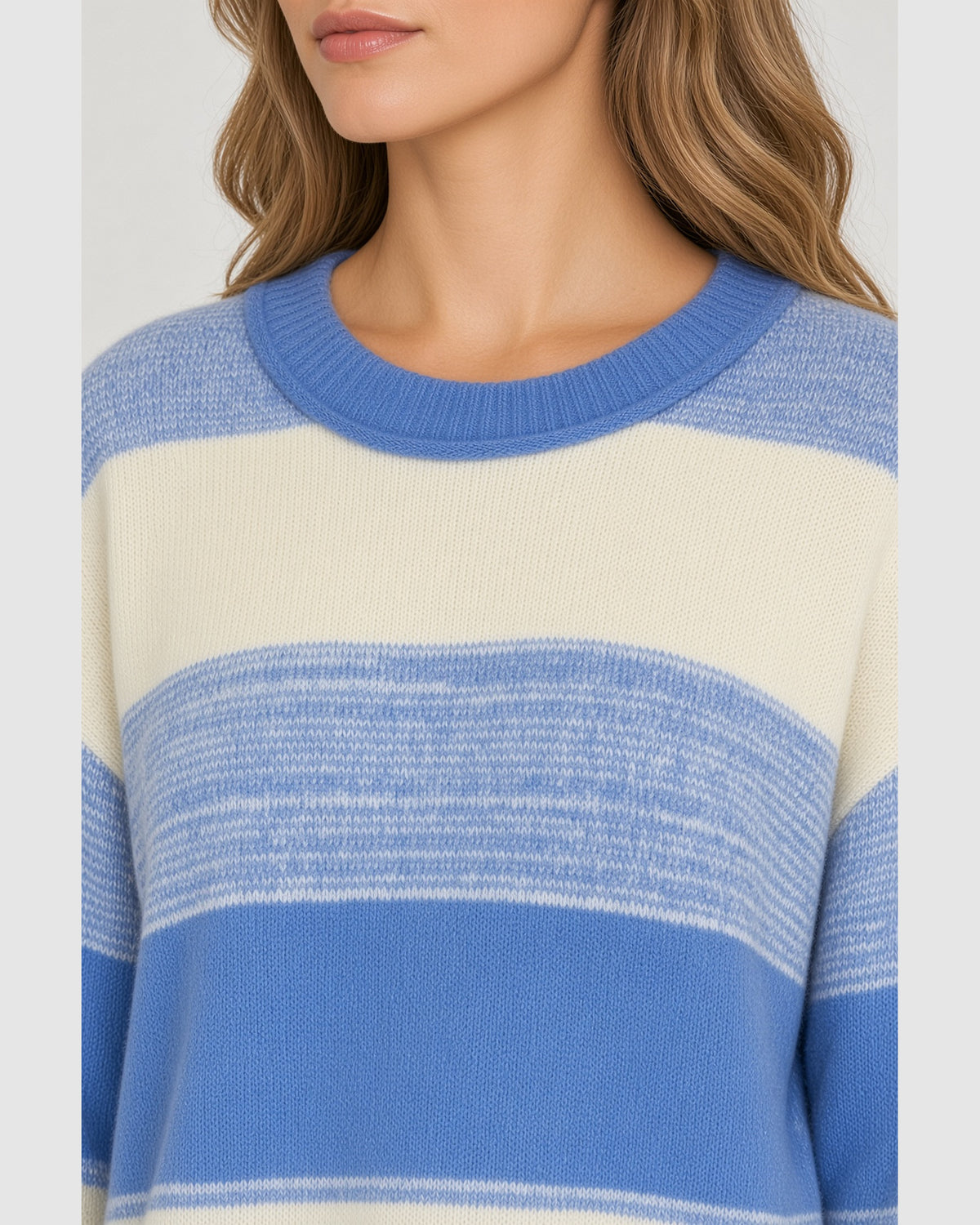Close up view of oversized blue and cream striped sweater showing wide stripes.