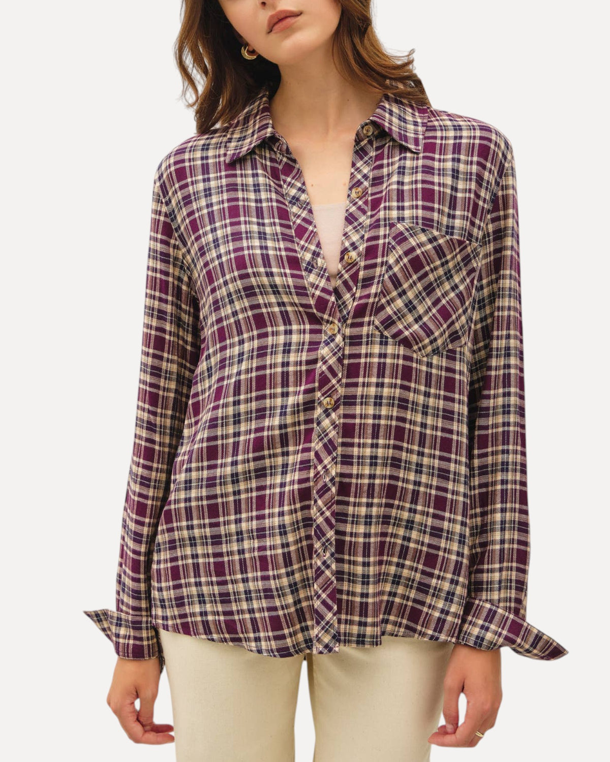 Model wearing a mixed plum plaid button down long sleeve top with a relaxed fit, cuffs and classic collar. 