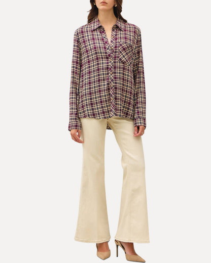 Model wearing a mixed plum plaid button down long sleeve top and khaki pants and nude heels.